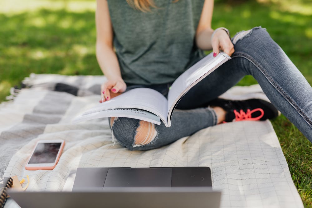 Woman studying from a book.