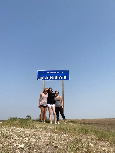 A photo with the Kansas state border sign.