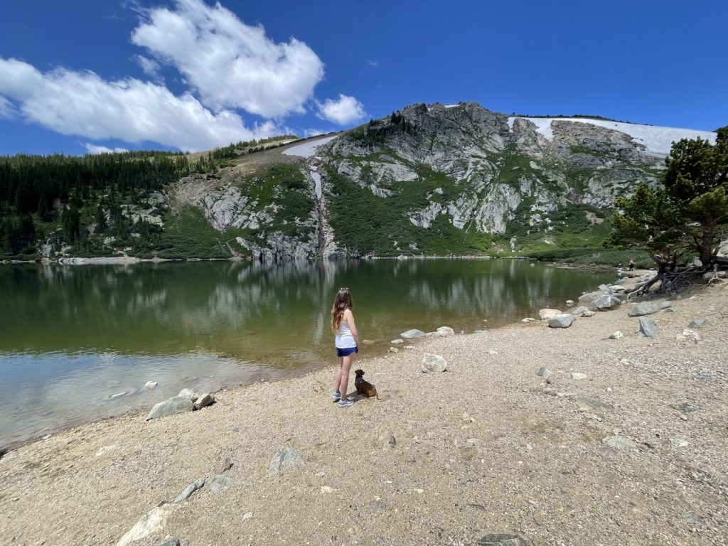 a girl and her dog at st. marys glacier