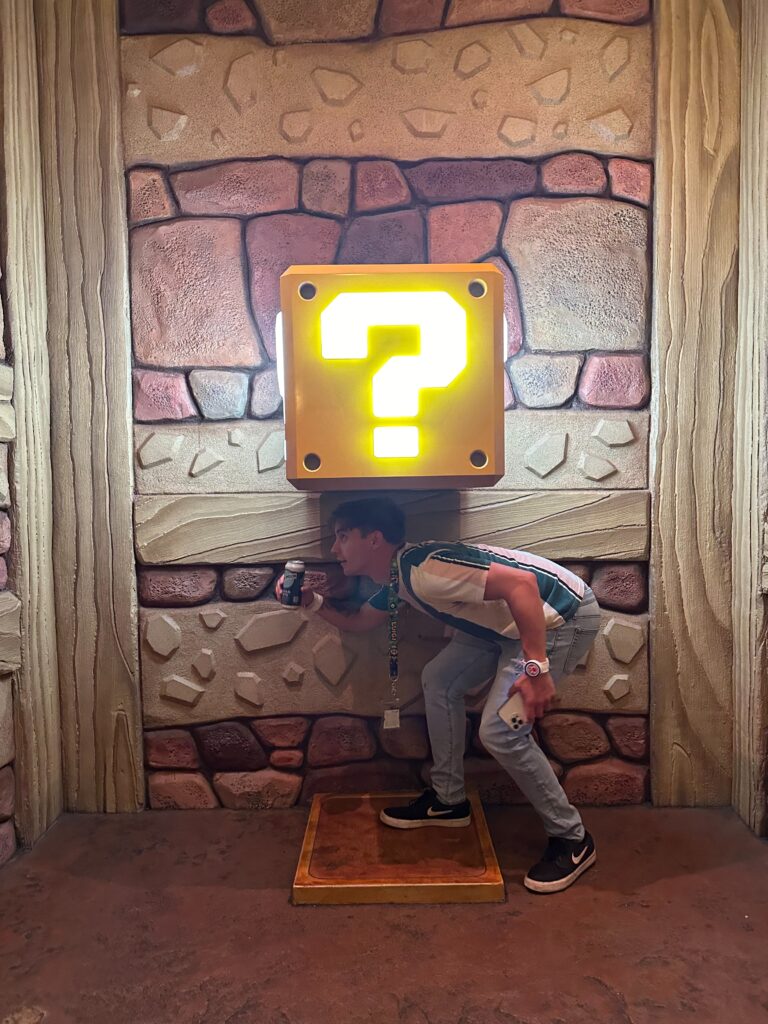 A boy head-butting the The "?" Block from Super Mario Bro's